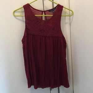 Maroon, high neck blouse.